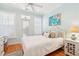 Light-filled bedroom with white furniture, wooden floor and coastal themed decorations at 1621 Folly Creek Way # D-8, Charleston, SC 29412