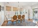 Bright dining room featuring a rustic table, stylish chairs, elegant lighting, and a welcoming view of the outdoors at 1621 Folly Creek Way # D-8, Charleston, SC 29412