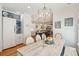 Elegant dining room featuring a long wooden table with chairs, a chandelier, and a clear view of the modern kitchen at 1621 Folly Creek Way # D-8, Charleston, SC 29412