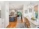 Spacious dining area with an elegant table setting and seamless transition to a modern kitchen and cozy living space at 1621 Folly Creek Way # D-8, Charleston, SC 29412