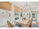 Inviting dining area with natural light, wood table, and a stylish chandelier for memorable meals at 1621 Folly Creek Way # D-8, Charleston, SC 29412