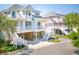 Elevated coastal home featuring dual balconies, white railing, and ample parking; perfect for beachfront living at 1621 Folly Creek Way # D-8, Charleston, SC 29412