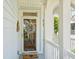 Welcoming front door with decorative wreath, showcasing coastal charm and inviting entrance to the home at 1621 Folly Creek Way # D-8, Charleston, SC 29412