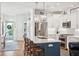 Well-lit kitchen featuring stainless steel appliances, white cabinets, an island with seating, and modern hanging lights at 1621 Folly Creek Way # D-8, Charleston, SC 29412