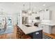 Bright kitchen with white cabinetry, stainless steel appliances, a central island with seating, and modern pendant lighting at 1621 Folly Creek Way # D-8, Charleston, SC 29412