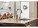 Kitchen island with sink, stainless steel faucet, and a marble countertop, all set in a bright open space at 1621 Folly Creek Way # D-8, Charleston, SC 29412