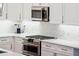 Gourmet kitchen features stainless steel appliances, a gas range, custom cabinets and modern marble backsplash at 1621 Folly Creek Way # D-8, Charleston, SC 29412