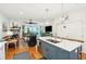 Open-concept kitchen featuring a large island with seating, stainless steel appliances, and seamless flow to the living area at 1621 Folly Creek Way # D-8, Charleston, SC 29412