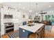 Open-concept kitchen and living area featuring an island with seating, modern appliances, and a view of the comfortable lounge at 1621 Folly Creek Way # D-8, Charleston, SC 29412