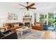Cozy living room featuring leather sofas, fireplace, ceiling fan and hardwood floors, perfect for relaxing at 1621 Folly Creek Way # D-8, Charleston, SC 29412