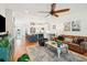 Cozy living room with a ceiling fan, leather sofa and chairs, a patterned rug, and a combined kitchen area at 1621 Folly Creek Way # D-8, Charleston, SC 29412