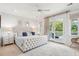 Elegant main bedroom with tufted headboard, plush bedding, and balcony access for a private retreat at 1621 Folly Creek Way # D-8, Charleston, SC 29412
