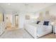 Spacious main bedroom with a tufted headboard, stylish decor, and access to the main bath and walk-in closet at 1621 Folly Creek Way # D-8, Charleston, SC 29412