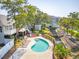 Refreshing community pool area with lounge chairs, landscaping and tranquil canal at 1621 Folly Creek Way # D-8, Charleston, SC 29412