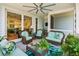 Relaxing screened porch features comfortable seating and a ceiling fan, perfect for enjoying outdoors at 1621 Folly Creek Way # D-8, Charleston, SC 29412