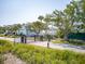 Gated community entrance lined with lush landscaping and mature trees at 1621 Folly Creek Way # D-8, Charleston, SC 29412