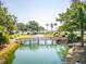Picturesque bridge and pond with water feature set amongst mature landscaping and palm trees at 1621 Folly Creek Way # D-8, Charleston, SC 29412