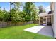 Large, green backyard with a concrete patio and screened-in porch at 167 Meadow Wood Rd, Summerville, SC 29486