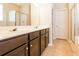 Bathroom with dual sinks, dark cabinets, large mirror, and tiled floor at 167 Meadow Wood Rd, Summerville, SC 29486
