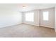 Spacious bedroom featuring neutral carpet, two windows, and a ceiling light at 167 Meadow Wood Rd, Summerville, SC 29486