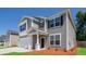 Charming two-story home features a two-car garage, neutral siding, and inviting front porch at 167 Meadow Wood Rd, Summerville, SC 29486