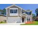 Charming two-story home features a two-car garage, neutral siding, and inviting front porch at 167 Meadow Wood Rd, Summerville, SC 29486