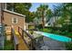 Backyard with pool, patio and lush landscaping accessible by wooden walkway at 171 Queen St, Charleston, SC 29401