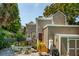 Charming backyard featuring a patio, garden, grill, and exterior view of the tan-colored home at 171 Queen St, Charleston, SC 29401