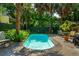 Backyard oasis featuring a refreshing pool, lush greenery, and outdoor dining area at 171 Queen St, Charleston, SC 29401