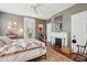 Charming bedroom featuring a decorative fireplace, hardwood floors, and tasteful wall art at 171 Queen St, Charleston, SC 29401