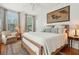 Sunlit bedroom featuring a large bed with plush pillows and a tasteful Asian-inspired painting on the wall at 171 Queen St, Charleston, SC 29401