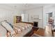 Inviting bedroom featuring a cozy quilt, hardwood floors, and a decorative fireplace at 171 Queen St, Charleston, SC 29401