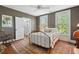 Cozy bedroom with dark gray walls, a metal bed frame, and lots of natural light from the windows at 171 Queen St, Charleston, SC 29401