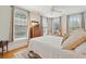 Comfortable bedroom with hardwood floors, multiple windows, and an antique wooden cabinet with flowers at 171 Queen St, Charleston, SC 29401