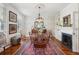Dining room featuring a decorative ceiling, chandelier, and a large wooden table for entertaining at 171 Queen St, Charleston, SC 29401