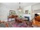 Dining room with hardwood floors, chandelier, and wallpaper at 171 Queen St, Charleston, SC 29401