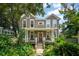 Charming two-story home with a inviting front porch and beautiful landscaping around the property at 171 Queen St, Charleston, SC 29401