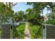 Landscaped front yard with a sidewalk leading to a charming two-story home with a inviting porch at 171 Queen St, Charleston, SC 29401