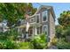 Side view of a charming two-story home with a cozy front porch and colorful landscaping at 171 Queen St, Charleston, SC 29401
