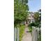 View of a charming two-story home with a cozy front porch, framed by a lush garden and walkway at 171 Queen St, Charleston, SC 29401