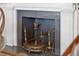 Detailed fireplace with decorative antique metal accents at 171 Queen St, Charleston, SC 29401