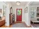 Bright foyer featuring a decorative rug, hardwood floors, and a decorative crystal chandelier at 171 Queen St, Charleston, SC 29401