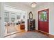 Elegant foyer with hardwood floors, a decorative rug, crystal chandelier, and classic details at 171 Queen St, Charleston, SC 29401