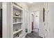 Hallway with built-in shelving and view of red front door at 171 Queen St, Charleston, SC 29401