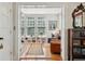 Bright home office featuring built-in bookshelves, hardwood floors and a view to the living area at 171 Queen St, Charleston, SC 29401