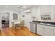 Bright eat-in kitchen with stainless steel appliances, wood floors, and table at 171 Queen St, Charleston, SC 29401