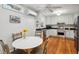 Bright kitchen with white cabinets, stainless steel appliances, and wood flooring at 171 Queen St, Charleston, SC 29401