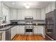 The kitchen features stainless steel appliances, granite countertops, and wood flooring at 171 Queen St, Charleston, SC 29401