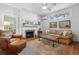 Cozy living room with a brick fireplace, hardwood floors, and large windows at 171 Queen St, Charleston, SC 29401