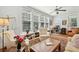 Sunny living room with built-in shelving, ceiling fan, and multiple seating options at 171 Queen St, Charleston, SC 29401